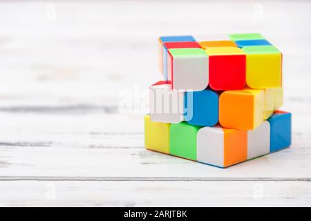 Rubik's Cube on white wooden background. Smart game concept. Free copy space. Stock Photo