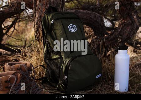 Olive green travel backpack with gear Stock Photo