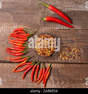 Hot chilli pepper sauce paste harissa, traditional Tunisia, Moroccan, Arabic cuisine adjika ,chili pepper spices and fresh red chilli peppers, over wo Stock Photo