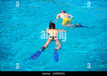 Seascape View To Turquoise Waters Of Aegean Sea In Island Moni Near Athens Blue Caves Famous Travel Sailing Destination Greece Europe Woman And Man Dive With Flippers And Mask Stock Photo