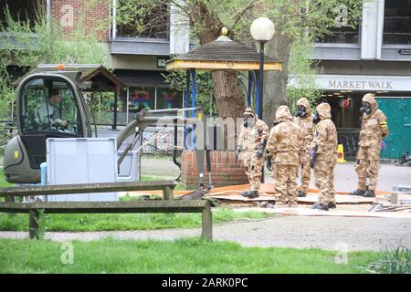Emergency services in hazmat suits removing the bench where former Russian Spy, Sergei Skripal and his daughter Yulia were found slumped aftr visiting Zizzi restaurant and The Mill pub. Stock Photo