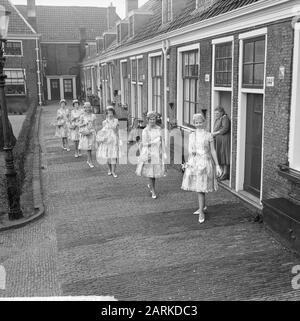 Haarlem flower girls in new suit, their new Boussac cotton dresses. Some girls at the Proveniershofje in Haarlem Date: March 18, 1963 Location: Haarlem Keywords: FLOWER GIRLS Stock Photo