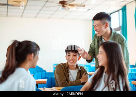 collage Student  discuss with Classmate in Classroom Stock Photo