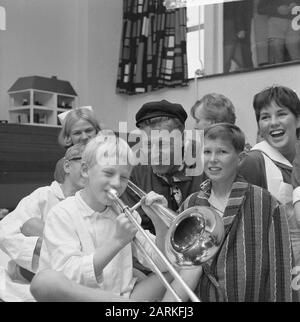 Gifts from the Wieringermeer for children in Emmaziekenhuis, little boy plays trombone Date: August 28, 1965 Location: Noord-Holland, Wieringermeer Keywords: GIFTS, Children  : Kroon, Ron/Anefo Stock Photo