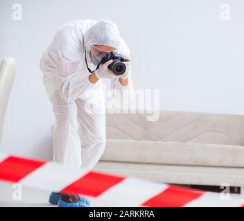 The forensic expert at crime scene doing investigation Stock Photo