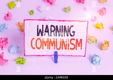 Handwriting text writing Warning Communism. Conceptual photo economic system where the group owns the production Colored crumpled papers empty reminde Stock Photo