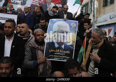 Gaza, Palestine. 28th Jan, 2020. A Palestinian protester holds a picture of Palestinian President, Mahmoud Abbas Abu Mazen during a protest against the US peace plan about the Middle East in Rafah. Credit: SOPA Images Limited/Alamy Live News Stock Photo