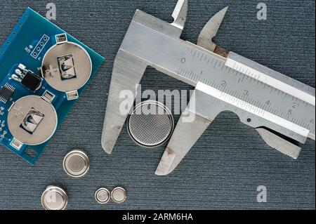 closeup button cell battery or watch battery or coin cell, used to power small electronics devices such as wrist watches or computer motherboard. Stock Photo