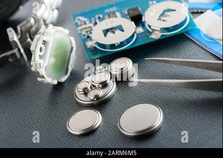 closeup button cell battery or watch battery or coin cell, used to power small electronics devices such as wrist watches or computer motherboard. Stock Photo