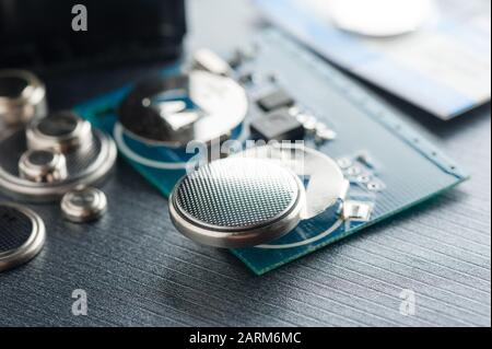closeup button cell battery or watch battery or coin cell, used to power small electronics devices such as wrist watches or computer motherboard. Stock Photo