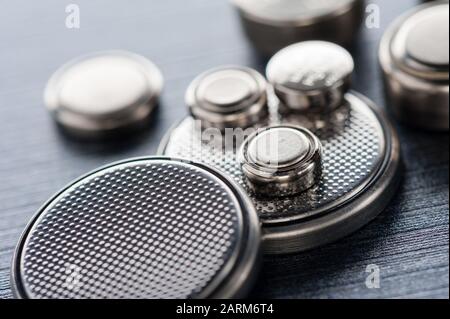 closeup button cell battery or watch battery or coin cell, used to power small electronics devices such as wrist watches or computer motherboard. Stock Photo