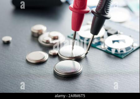 closeup button cell battery or watch battery or coin cell, used to power small electronics devices such as wrist watches or computer motherboard. Stock Photo