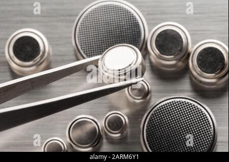 closeup button cell battery or watch battery or coin cell, used to power small electronics devices such as wrist watches or computer motherboard. Stock Photo