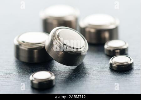 closeup button cell battery or watch battery or coin cell, used to power small electronics devices such as wrist watches or computer motherboard. Stock Photo