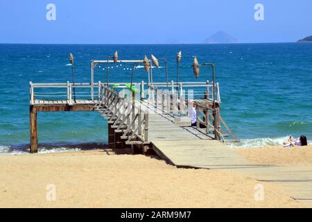 People enjoy the promenade and beach at the seaside resort of  Nha Trang in Vietnam, South East Asia, Indochina, Asia, on a hot, sunny day. Stock Photo