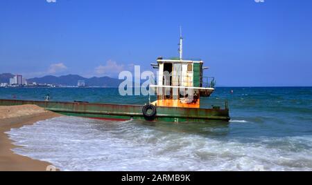 In December 2019 a ferry barge bearing the number KH-98668-TS drifted and was washed into Nha Trang beach at the seaside resort of Nha Trang in Vietnam, South East Asia, Indochina, Asia,and is still stuck aground on the sand east of Tran Phu Street, Nha Trang, on January 29, 2020. Stock Photo