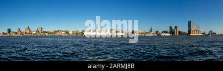 Panorama/Skyline of Hamburg harbor from the opposite side of the Elbe river with the Michel church, TV Tower and the museum ship Cap San Diego Stock Photo