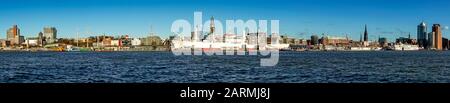 Panorama/Skyline of Hamburg harbor from the opposite side of the Elbe river with the Michel church, TV Tower and the museum ship Cap San Diego Stock Photo