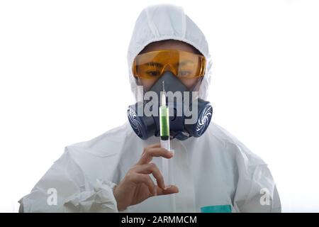 Woman in a chemical protective clothing and antigas mask with glasses at white background, Women scientist in safety suit, Safety virus infection conc Stock Photo