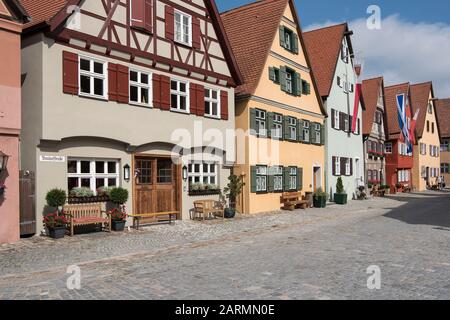 Dinkelsbühl, Germany - July 16, 2019; Half timbered colorful houses in a street in Dinkelsbühl an touristic and historic town on the romantic road Stock Photo