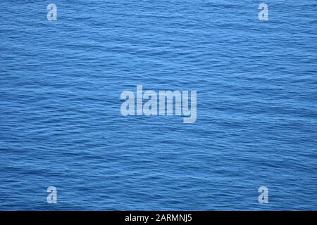 Blue water surface pattern with cross waves similar to woven fabric. Stock Photo