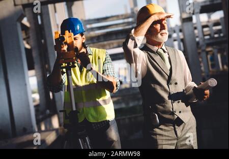 Team of construction engineers, architects working on building site Stock Photo