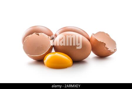 Chicken eggs and broken egg with yolk isolated on white background. Stock Photo