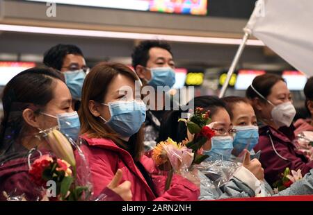 (200129) -- TIANJIN, Jan. 29, 2020 (Xinhua) -- The second batch of medical workers pose for a group photo before their departure to Wuhan of Hubei Province, at Binhai International Airport in Tianjin, north China, on Jan. 28, 2020. A team comprised of 138 members from 16 hospitals in Tianjin left for Wuhan on Tuesday to aid the coronavirus control efforts there. (Xinhua/Ma Ping) Stock Photo