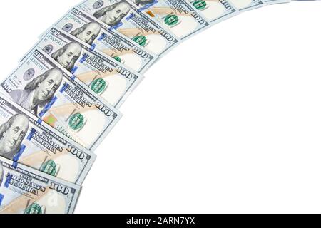 Banknotes of dollars are stacked in a row. Isolated white background. Stock Photo