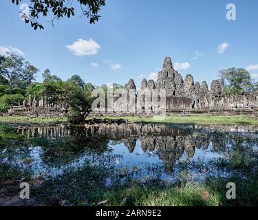 Siem Reap Temple Site. Bayon Temple reflected in water. Stock Photo