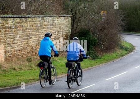 Two male cyclists in winter,  Northamptonshire, England, UK Stock Photo