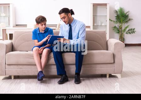 The internet addicted boy visiting male doctor Stock Photo