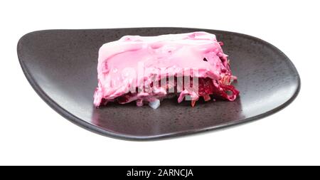portion of Dressed herring russian salad on black plate isolated on white background Stock Photo