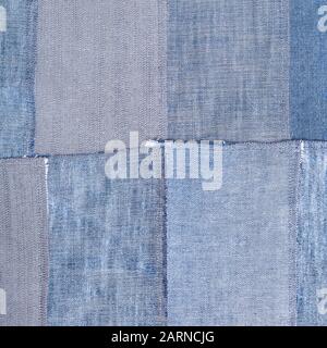 textile square background - patchwork from old denim flaps Stock Photo