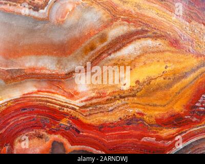 background from polished natural banded Calcite Onyx rock (onyx marble, Limestone Onyx) close up Stock Photo