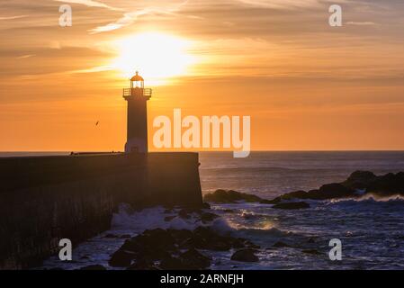 Felgueiras Lighthouse during sunset over Atlantic Ocean in Foz do Douro district of Porto city, second largest city in Portugal Stock Photo