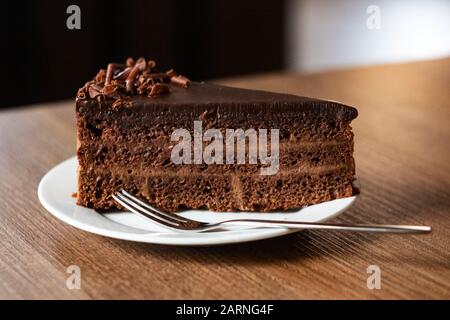 Chocolate cake on a plate and fork Stock Photo