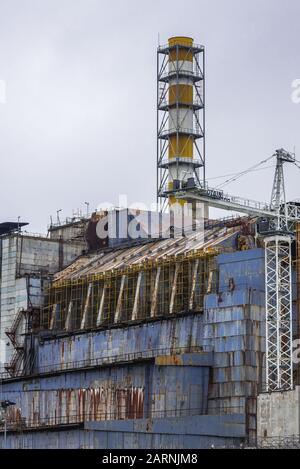 Old steel and concrete sarcophagus of reactor No 4 of Chernobyl Nuclear Power Plant in Zone of Alienation in Ukraine Stock Photo