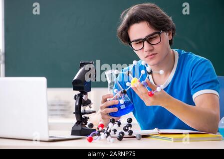 The young male student in the classroom Stock Photo