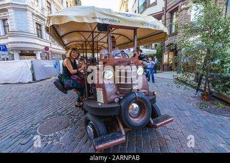 Party bike (also called cycle pub, beer bike or megacycle) on the Old Town of Riga, capital city of Republic of Latvia Stock Photo