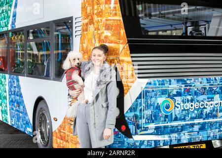 EMBARGOED TO 0001 THURSDAY JANUARY 30EDITORIAL USE ONLY Aislin Smith and dog Faith attend the unveiling of a one-of-a-kind mosaic bus livery, which features the faces of Stagecoach customers and drivers from across the UK, is unveiled to celebrate the launch of its new look bus design in its 40th year of service, at the Chesterfield depot in Derbyshire. PA Photo. Issue date: Thursday January 30, 2020. The one-off design created using photos from a year-long project with photographer Stuart Roy Clarke launches Stagecoach's new look colour coded buses, which will be rolled out across the fleet o Stock Photo