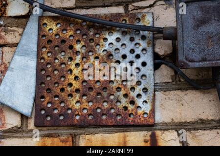 Metal grill on the old brick wall Stock Photo