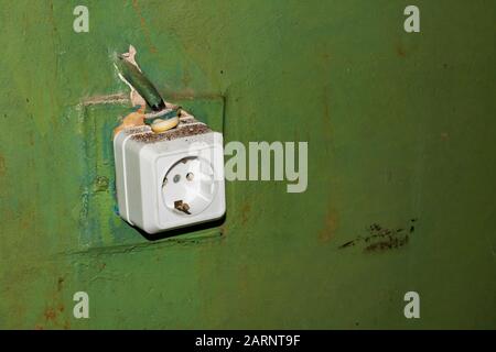 Socket on the old green wall close up Stock Photo