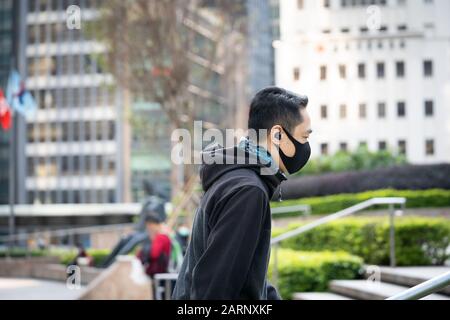 Hong Kong, January 29th, 2020: A young man wearing a protective mask to reduce risk of contracting corona virus. Stock Photo