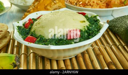 Ugali Sukuma Wiki, made with collard greens, known as sukuma, cooked with onions and spices. Kenyan cuisine, Traditional assorted African dishes, Top Stock Photo