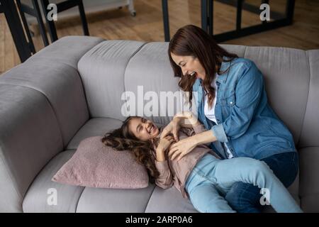 Daughter and mom play fun and joy at home. Stock Photo