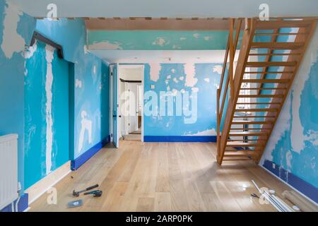 Room home improvement with a new wooden floor and walls prepared for painting Stock Photo