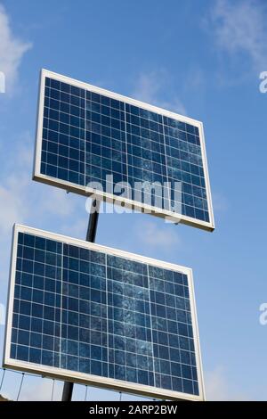 Solar panels against a blue sky, UK. These are small panels used to provide power in remote locations Stock Photo