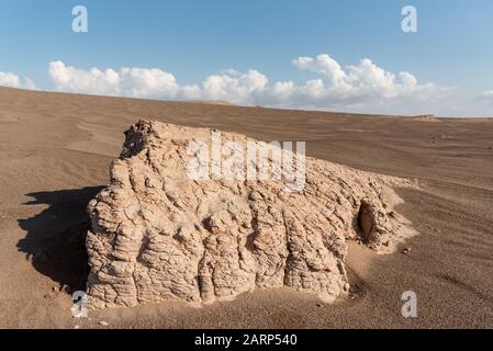 the formation of kaluts or sand stones in dasht e lut or sahara desert, after raining weather with cloudy sky Stock Photo