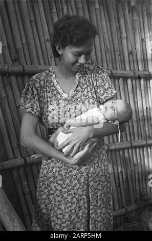 Portrait photos (miscellaneous) [passport photos]  Indonesian woman holding baby Date: 1947/01/01 Location: Indonesia, Dutch East Indies Stock Photo